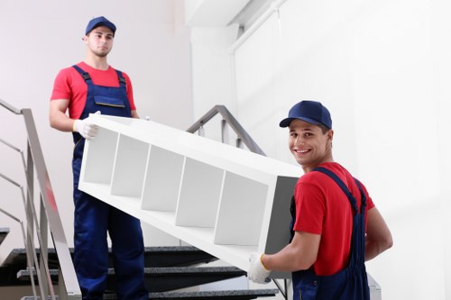 Local removal team unloading boxes into a modern Kentish Town apartment