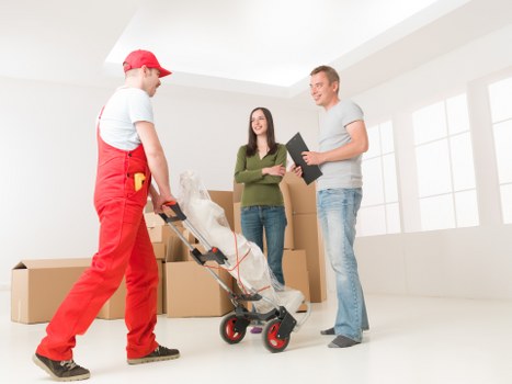 Professional moving team handling household items in a Kentish Town property