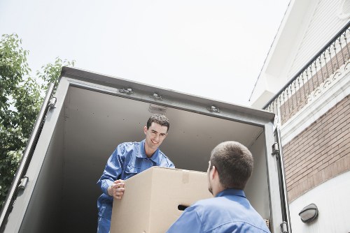 Local movers handling desks and office items during relocation